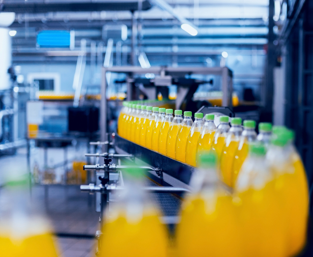Juices on a conveyor belt in a manufacturing building
